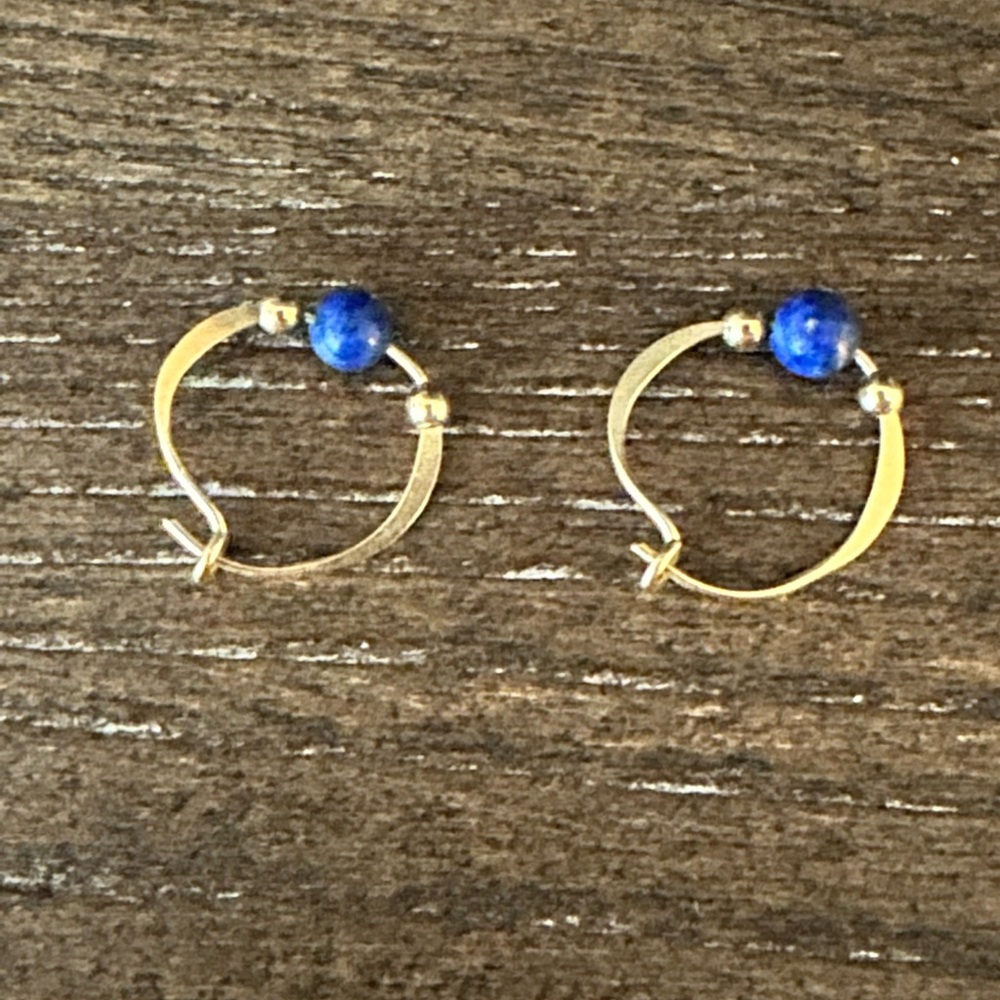 Gold tone earring with blue and gold beads.